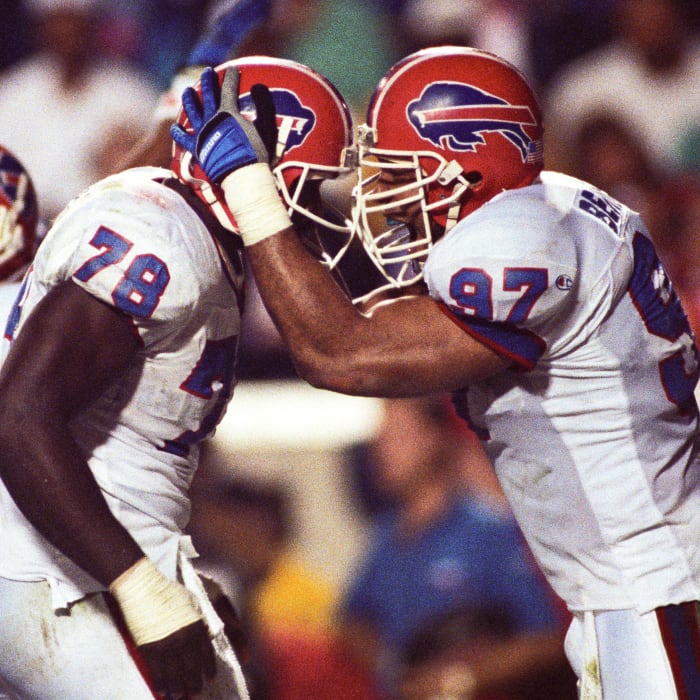 Buffalo Bills defensive end Bruce Smith (78) and linebacker Cornelius Bennett (97) react on the field during Super Bowl XXV against the New York Giants at Tampa Stadium. The Giants defeated the Bills 19-20.